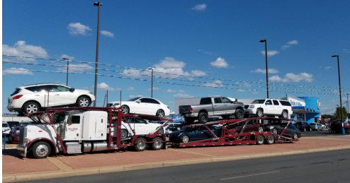 photo of a trailer truck carrying cars