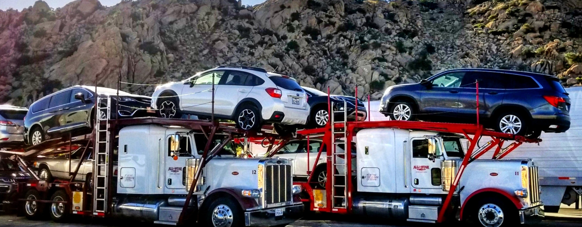 two trailer truck loaded with cars